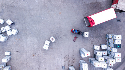 Warehouse man worker with forklift. Loading truck. Aerial