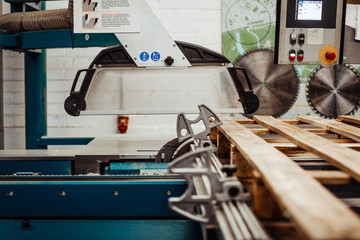 A wooden studio with a big cutting equipment cutting a big woods