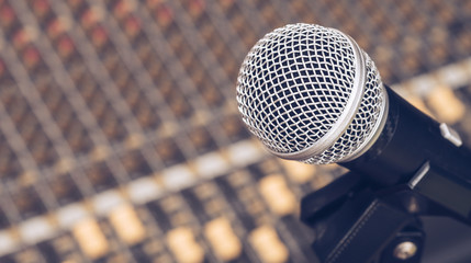 dynamic microphone on audio mixing board background