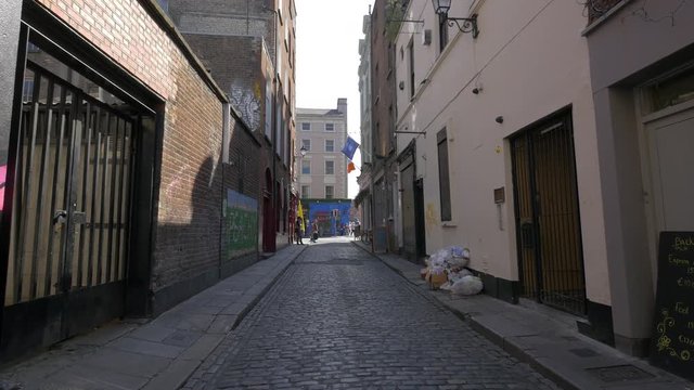 A narrow street with cobblestone pavement