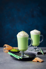 Matcha green tea latte with whipped cream. Copy space.