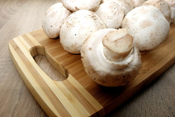 Mushrooms champignon on rustic background