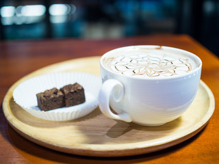 A cup of hot chocolate with milk froth.