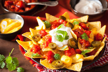 nachos loaded with salsa, cheese and jalapeno