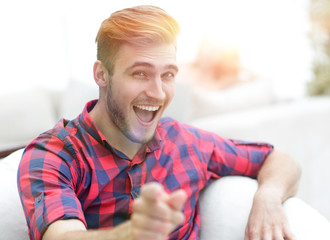 closeup of happy young man showing forward,