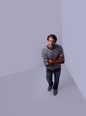 modern man standing in the corner of the white room .