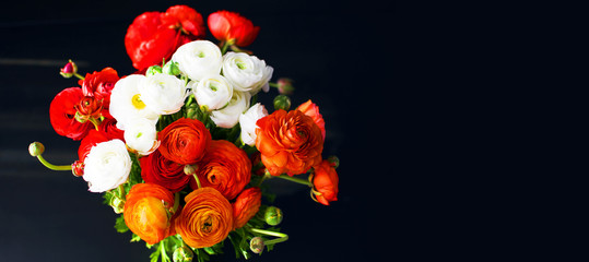 Fototapeta na wymiar Beautiful fresh bouquet of red, orange and white ranunculus, pions. Blossoming flowers texture, top view, flat lay. Spring or Mothers Day Concept