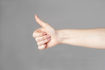 The man's hand shows a gesture of approval. Thumbs up. The hand shows gesture class. Everything is cool, you're done, praise, everything is OK, wonderful mood.