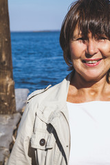 Fototapeta premium Portrait of adult woman on river bank