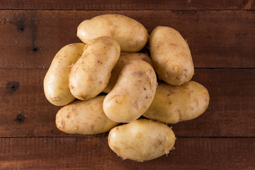 Potatoes on a rustic wooden background
