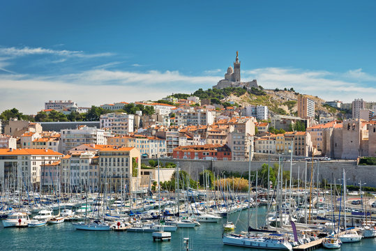 View of the old port of Marseille  with Notre Dame de la Garde basilica in the background, France
