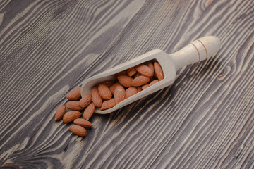 nuts almonds on scales and wooden background