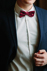 Expensive dark blue suit, white shirt and Burgundy tie