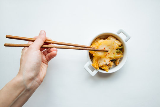 Little bowl of homemade kimchi on white table