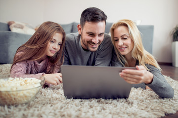 Young family watching a movie on laptop