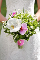 Beautiful wedding bouquet in hands of a bride