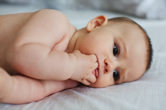 Cute baby on a bed.