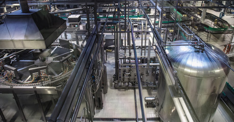 Brewery production line, steel tanks or vats for beer fermentation and manufacturing, pipelines and modern machinery