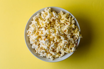 popcorn on yellow background, top view, minimalism