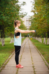 Smiling girl posing with a skipping rope