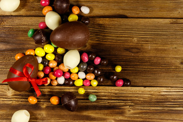 Easter composition with chocolate eggs on wooden background