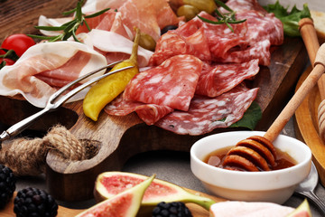 Italian antipasti wine snacks set. Cheese variety, Mediterranean olives, pickles, Prosciutto di Parma and salami