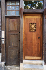 Old, historic wooden door to a tenement house in France.