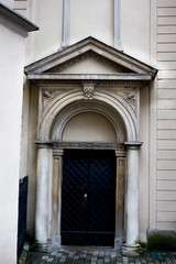 Vintage iron forged door with stucco and columns