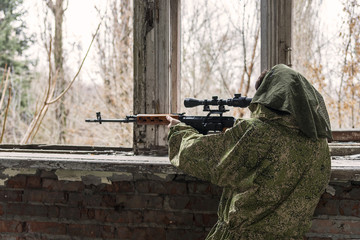 Fototapeta premium in the ruins of the building sniper waiting for the target