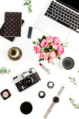 Fototapeta na wymiar Woman home office desk. Workspace with laptop, rose flowers, retro camera, accessories and cosmetics on white background. Flat lay, top view fashion blog concept.