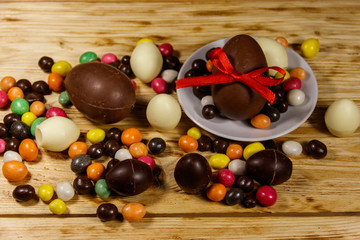 Easter composition with chocolate eggs on wooden background