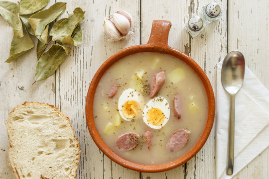 Traditional polish soup called Zurek served with bread