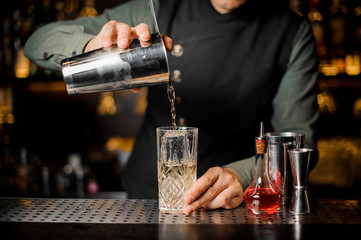 Fototapeta na wymiar Barmen making cocktail at the bar counter