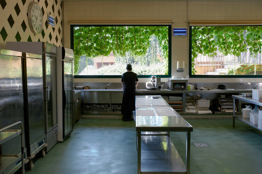 Lonely chef in his big kitchen at the begining of a long workday