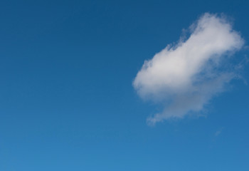 Naklejka na ściany i meble Blue sky with a white cloud.