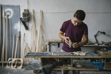 Young carpenter working at his workshop