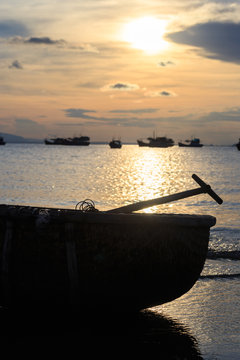 Vietnamese fishing boat silhouettes in sea at sunset