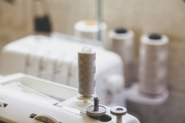 Beige thread on sewing machine