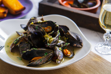 Freshly prepared mussels with vegetables in wine close-up