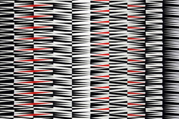 Piękny dywan, geometryczne wzory, białe, czarne i czerwone.