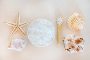 Obraz na płótnie Canvas Sea Salt with spoon and starfish on wooden background, spa
