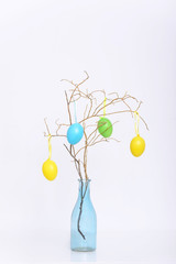 Simple easter decoration with egg on branch in bottle