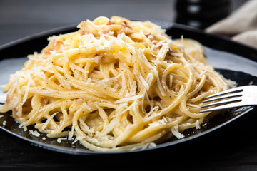 Spaghetti carbonara with egg and pancetta