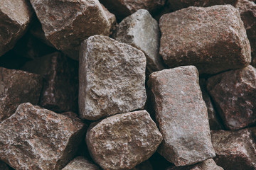 Texture backdrop background pile, wall of stone, bricks, cobblestones of brown and gray colors, rectangular, parallelepiped forms