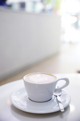 ccappuccino or Latte art coffee made from milk on the white table in coffee shop