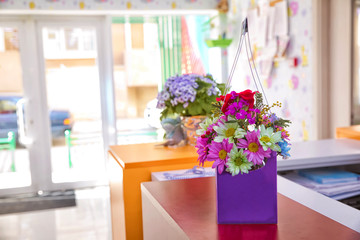 Purple flower bouquet made from paper . Lilac daisy . Purple flower isolated with clipping path . Bouquet of wild flowers clover in a cup