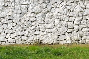 Part of the wall with a green lawn