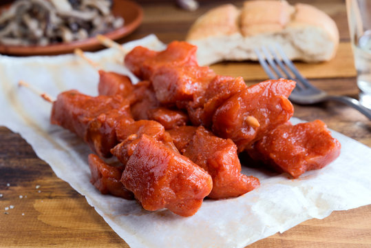 skewer of raw marinated meat on wood