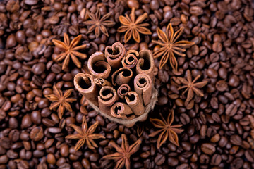 Coffee beans and cinnamon on a background of burlap. ,