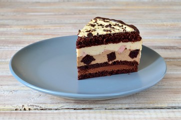 Piece of chocolate mousse cake on gray plate